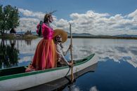 Vibrant catrina figures in traditional attire float on Cuitzeo Lake, capturing Mexican cultural essence.