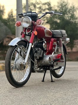 Classic red motorcycle on a suburban street during sunset. Ideal for nostalgia or travel themes.