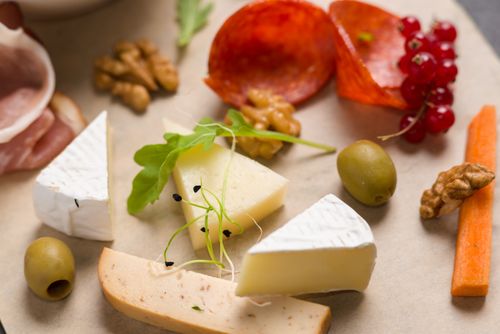 Free A gourmet selection of cheeses, meats, and garnishes beautifully arranged. Stock Photo