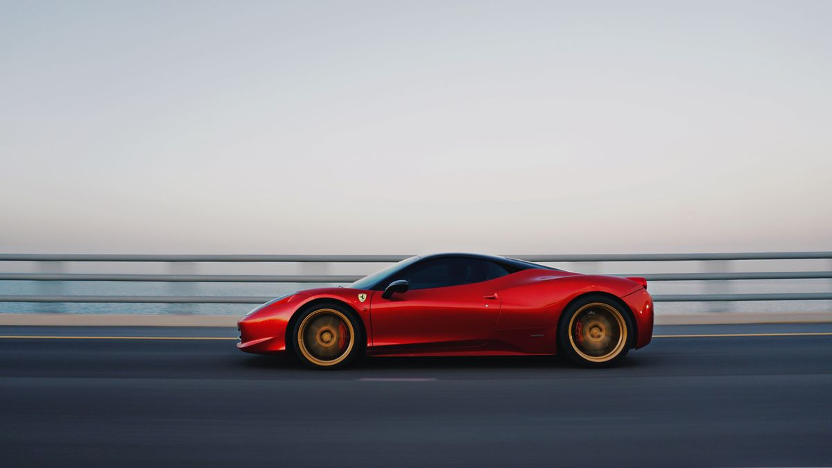 Best Credit Card for Gas 2026 - red car driving on scenic coastal road