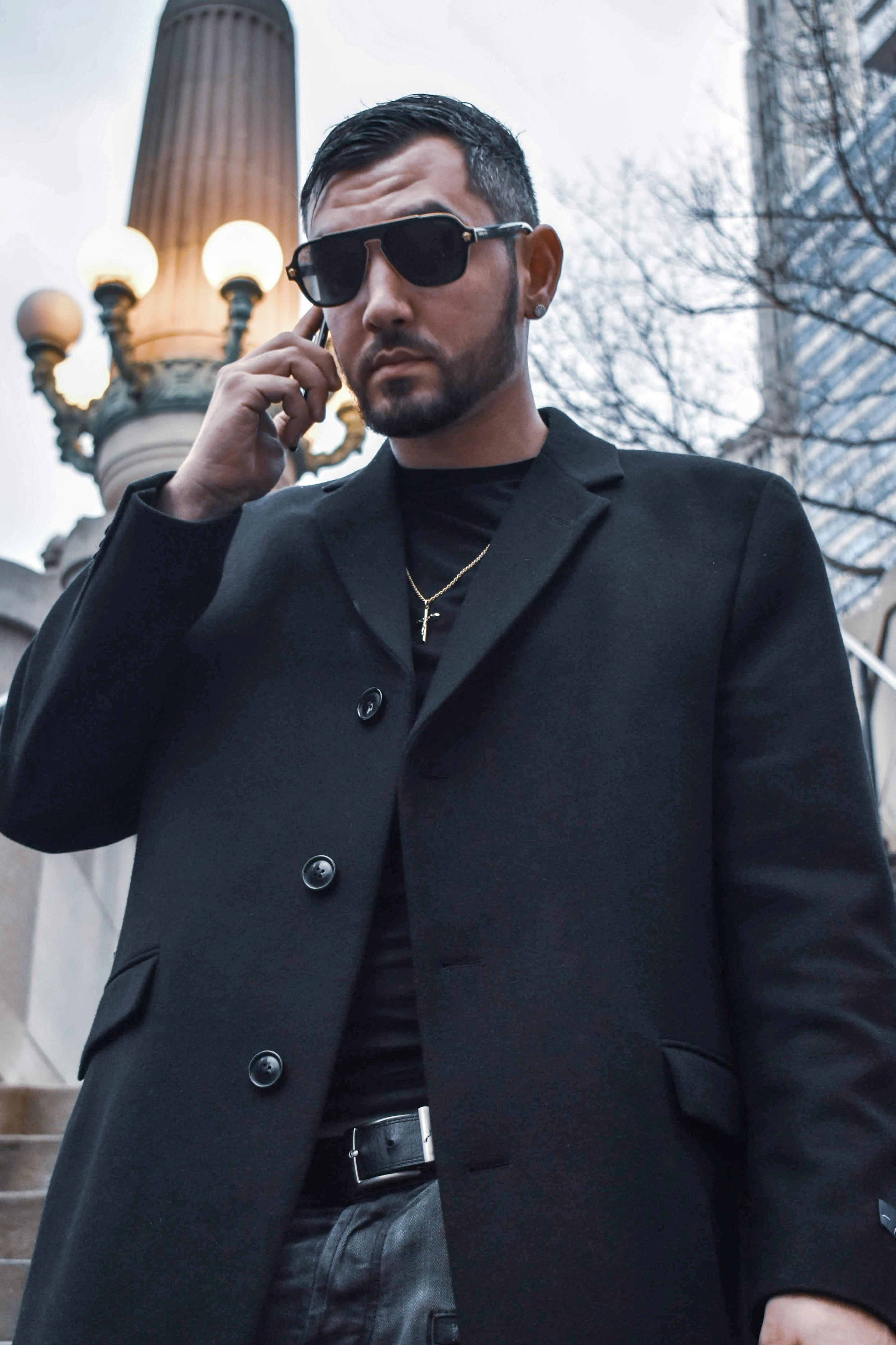 serious man talking on smartphone on street