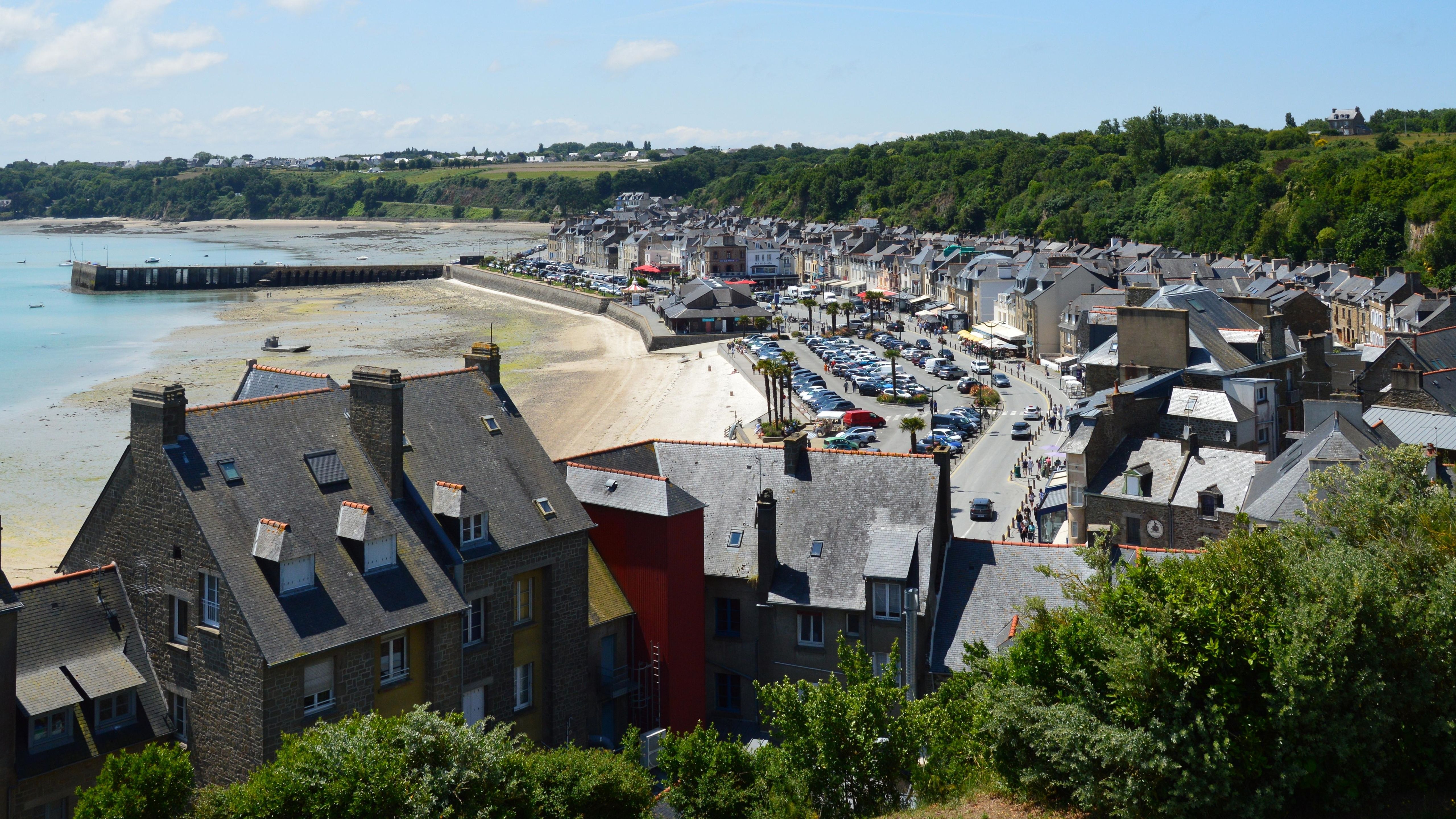 Aerial view of the seaside town of Cancale in Brittany, France, showcasing its picturesque coastline and architecture.