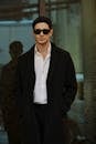 Stylish Man in Black Coat with Sunglasses