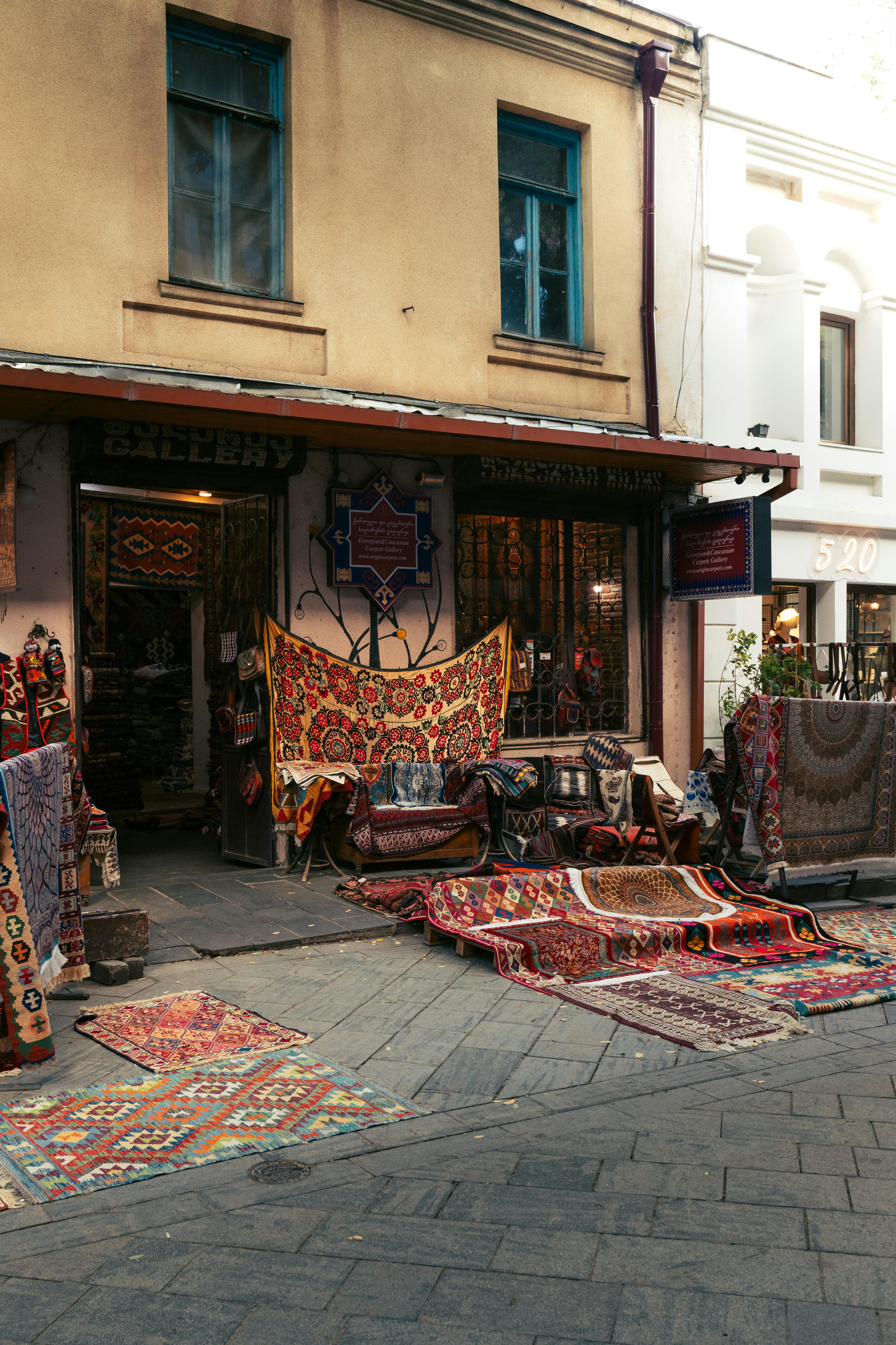 Vibrant outdoor display of traditional carpets in Tbilisi's historic district, Georgia.