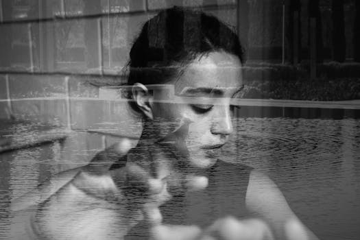 A black and white double exposure of a thoughtful woman and a serene lake scene.