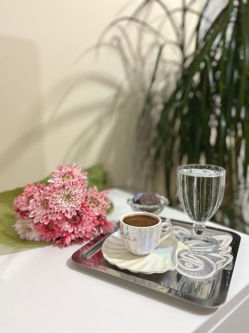 Free Elegant setup featuring Turkish coffee and flowers on a stylish tray. Stock Photo