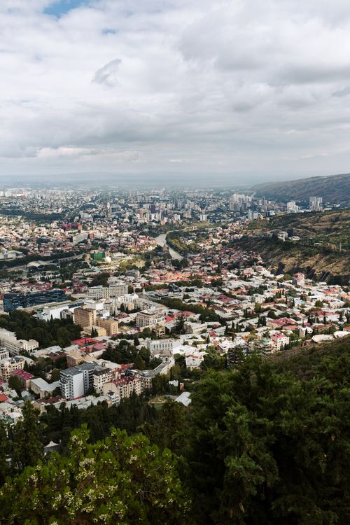 Free Stunning aerial view of Tbilisi with diverse architecture and sprawling greenery. Stock Photo