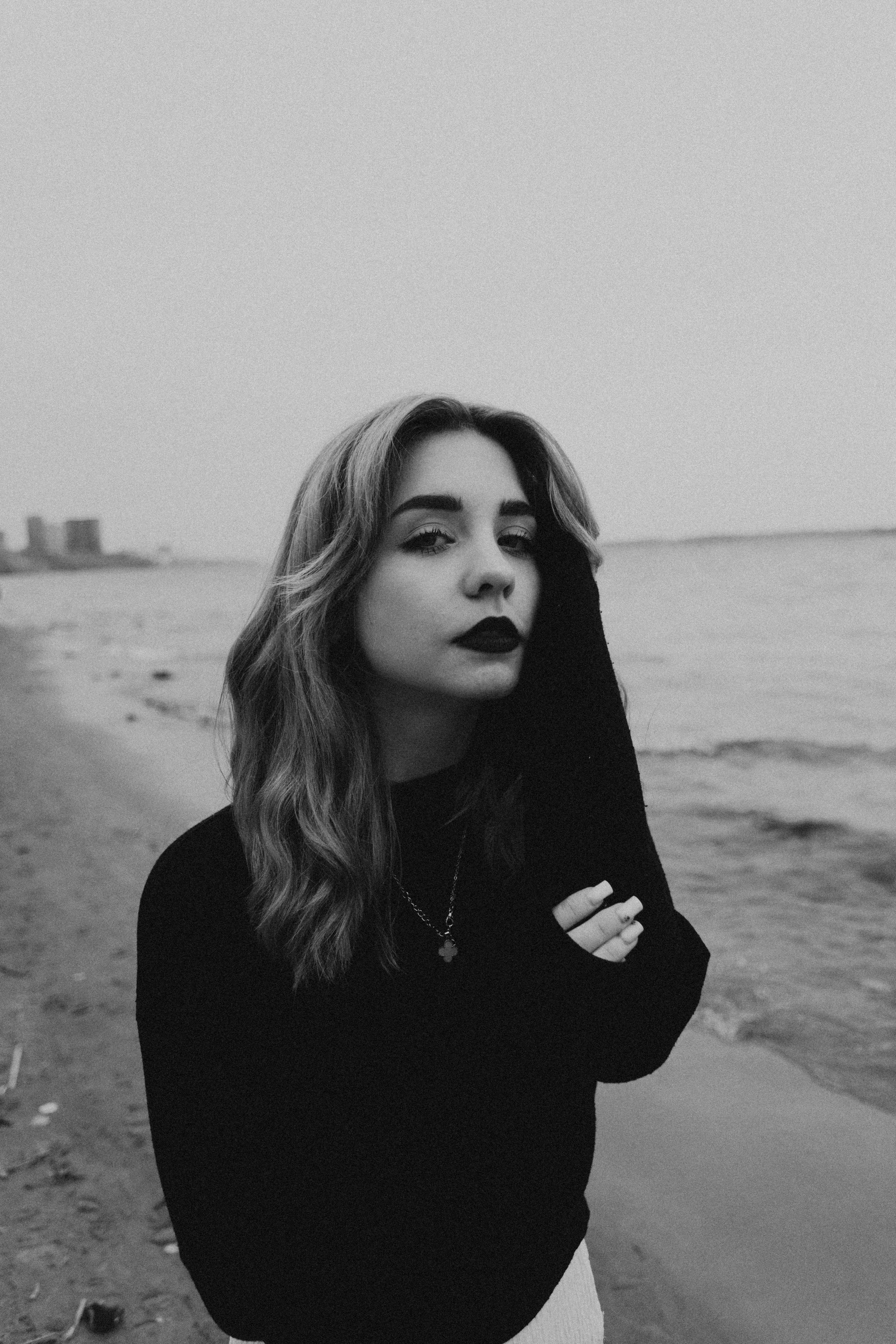 Young Woman in Black and White Beach Portrait · Free Stock Photo