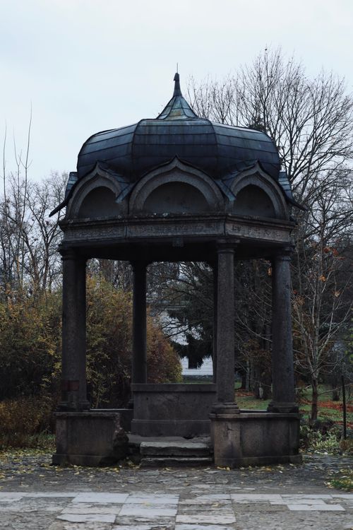 Free A stone gazebo stands majestically in a wintry park with bare trees. Stock Photo