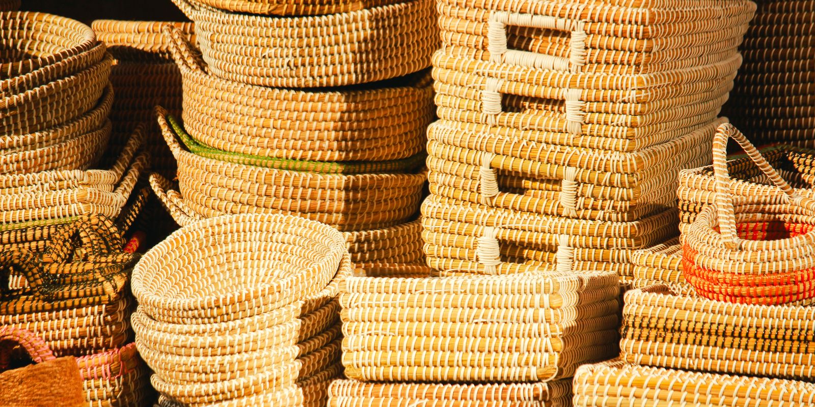 Handwoven baskets displayed in warm sunlight at a craft market