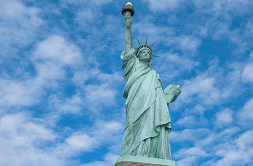 Free The iconic Statue of Liberty with a clear blue sky background in New York City. Stock Photo