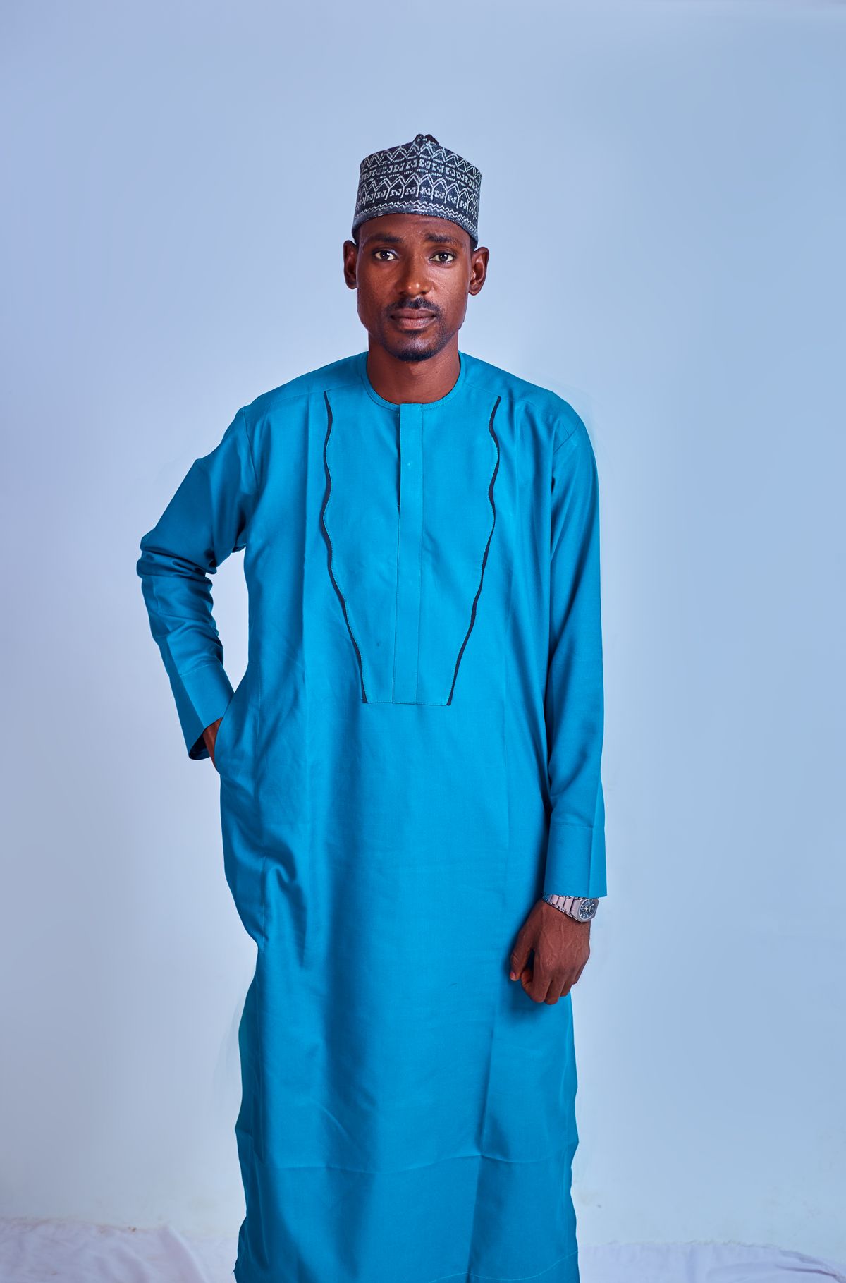 Man wearing a sophisticated blue traditional outfit