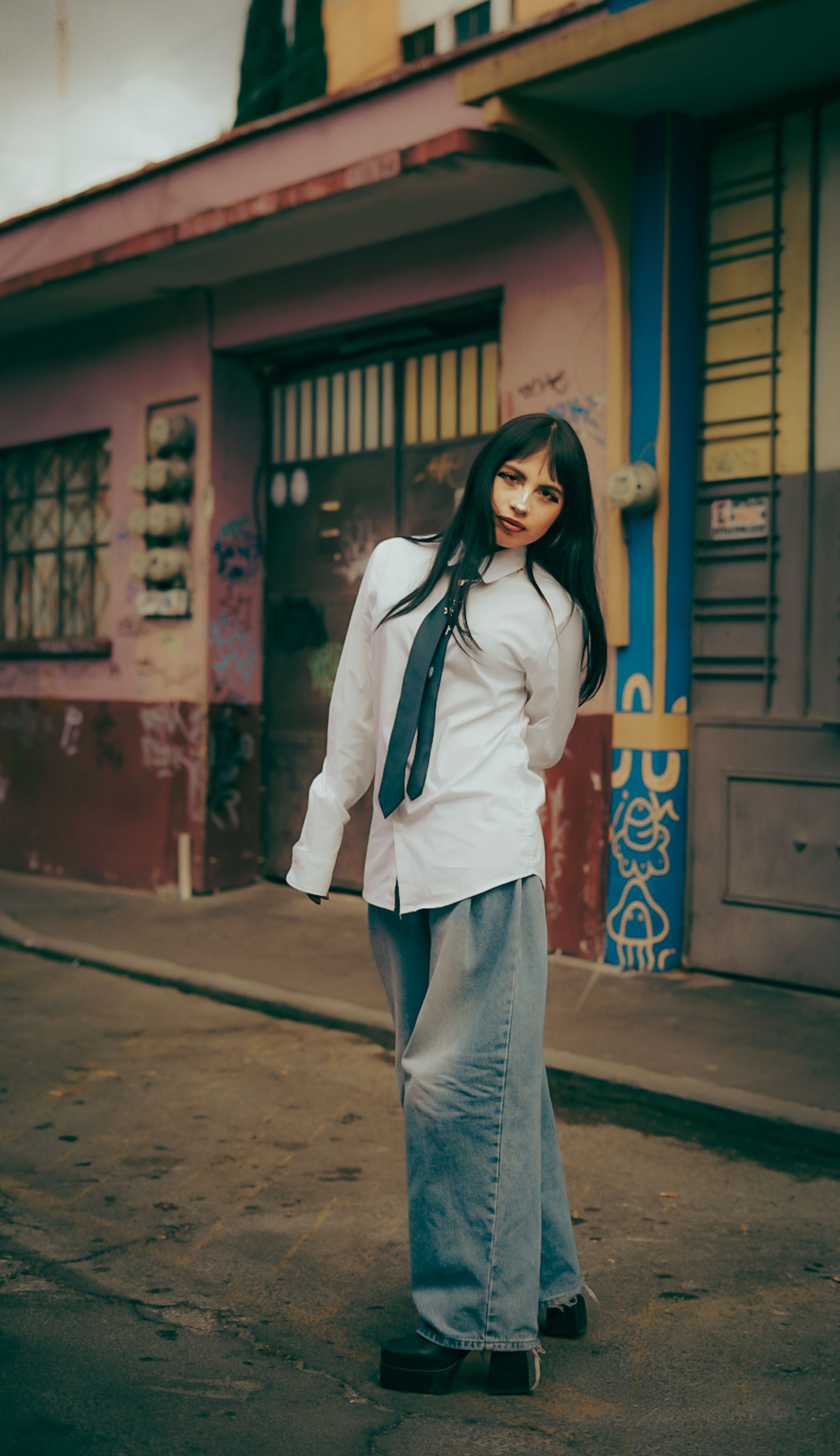 Young Woman Posing in Urban Street Setting · Free Stock Photo