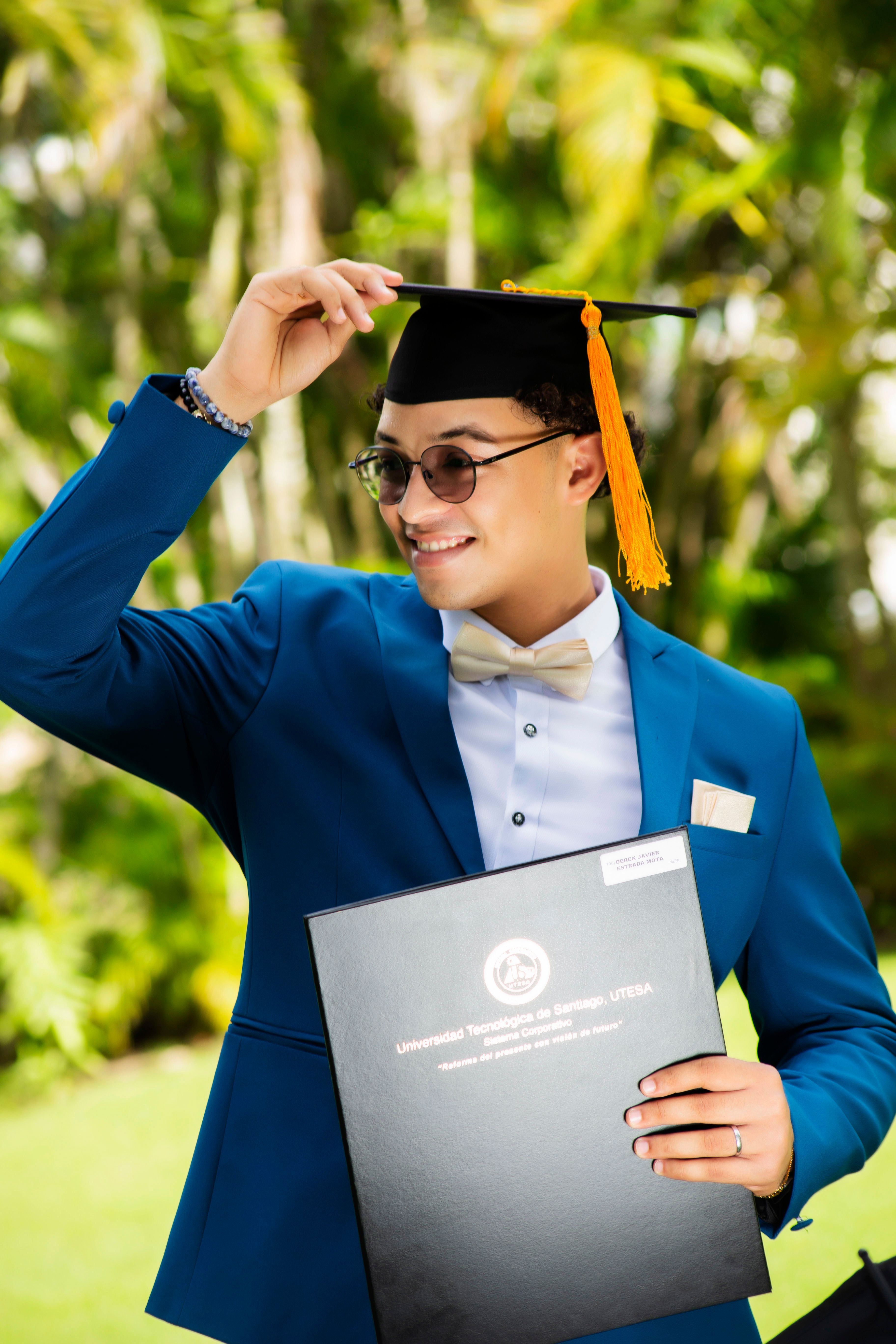 Young Graduate Celebrating in Blue Suit Outdoors · Free Stock Photo