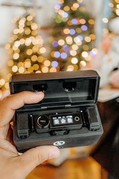 Close-up of audio recorder with festive bokeh lights in the background.