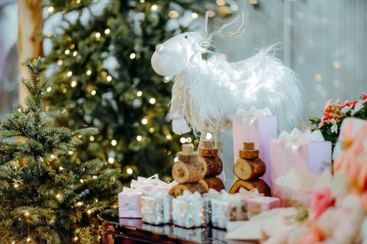 A cozy holiday scene with Christmas tree, reindeer decor, and wrapped gifts.