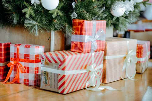 Free A variety of wrapped gift boxes under a Christmas tree, perfect for holiday themes. Stock Photo