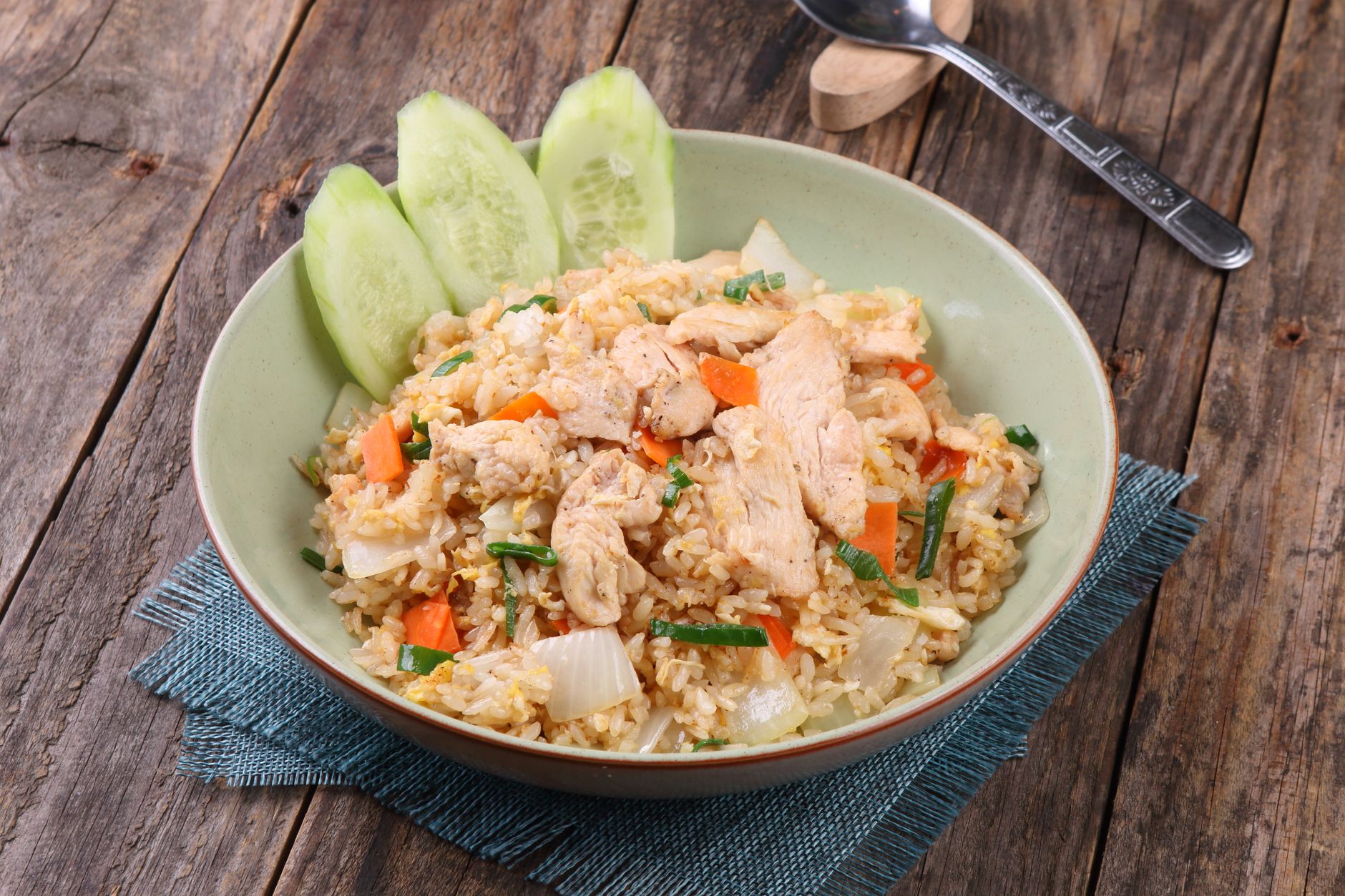 Cooked chicken with colorful sauted vegetables and rice in skillet