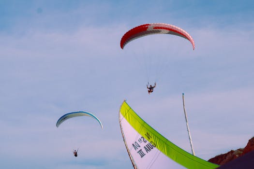 Vivid capture of paragliders soaring in clear skies, showcasing adventure and freedom.