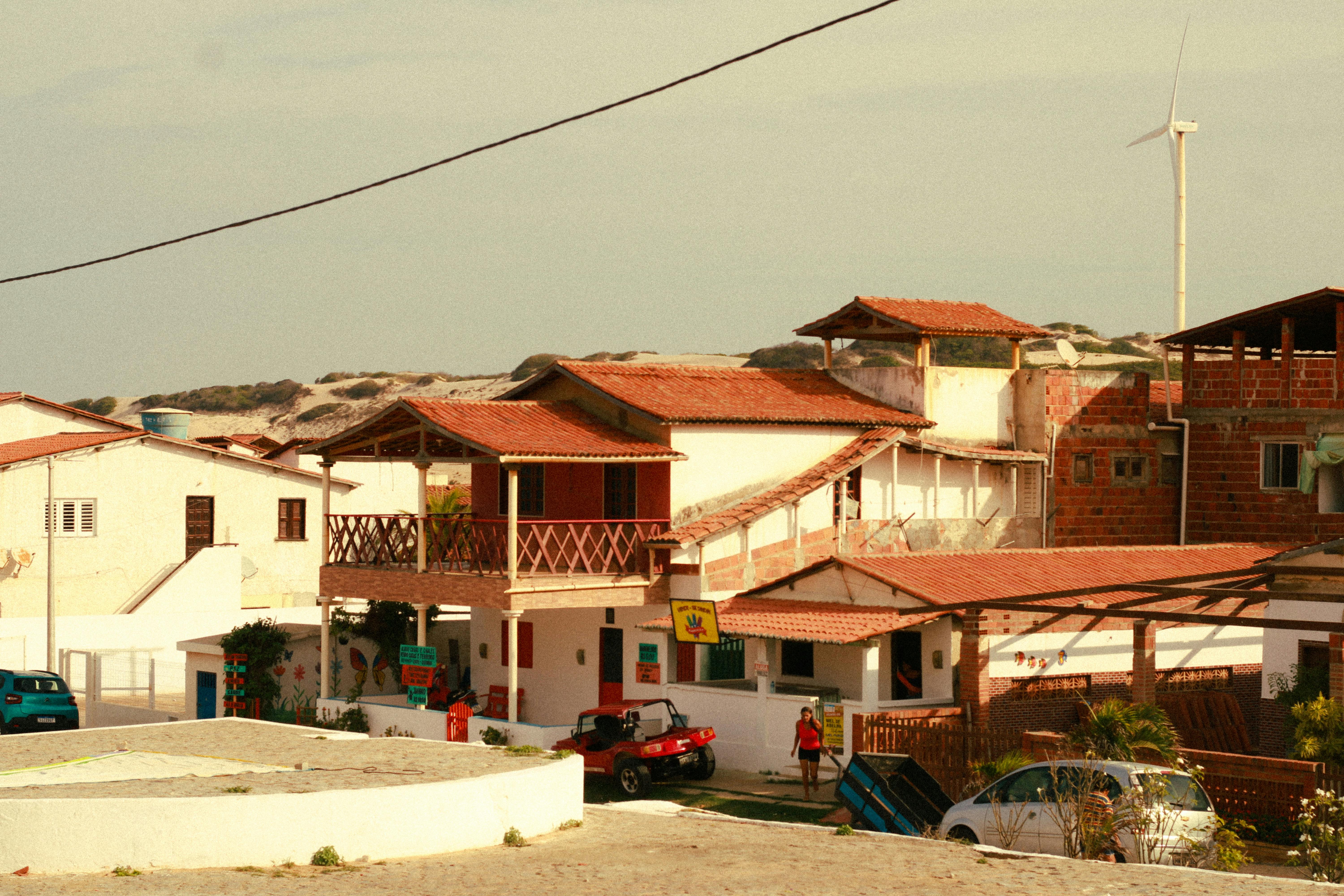 A picturesque view of traditional Brazilian beach houses under a clear sky.