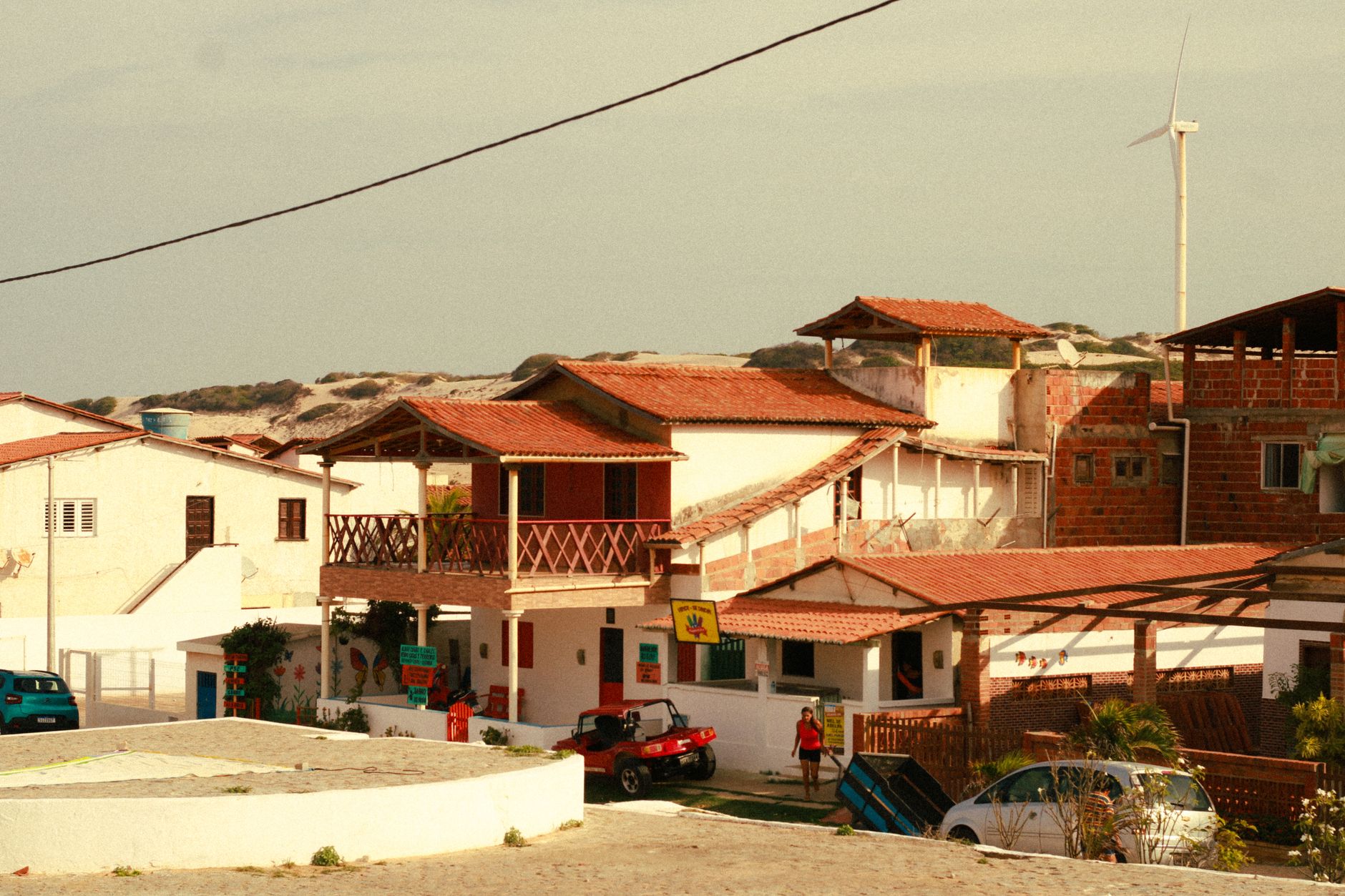 A picturesque view of traditional Brazilian beach houses under a clear sky.