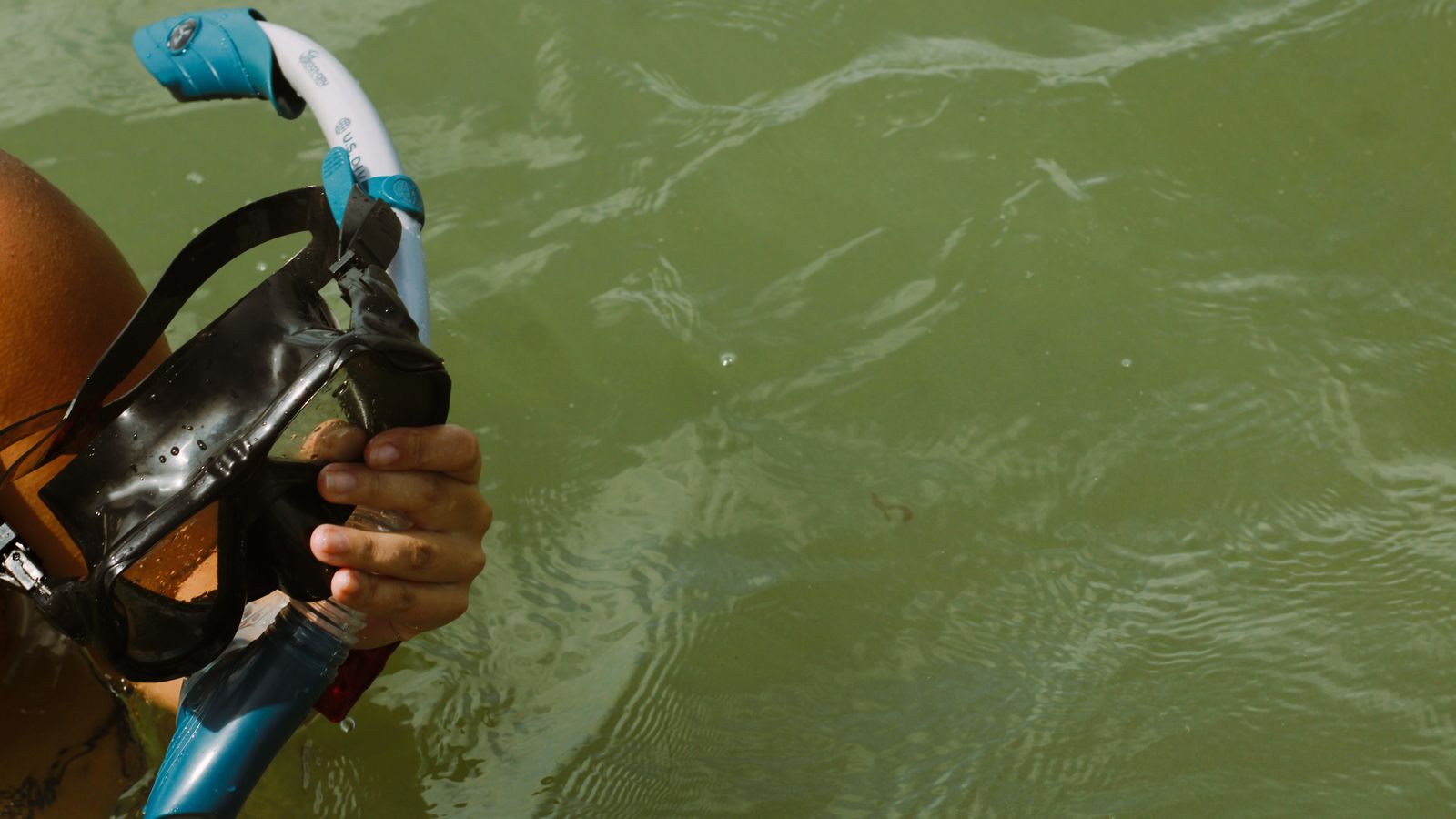Person holding snorkel mask in water, Djibouti