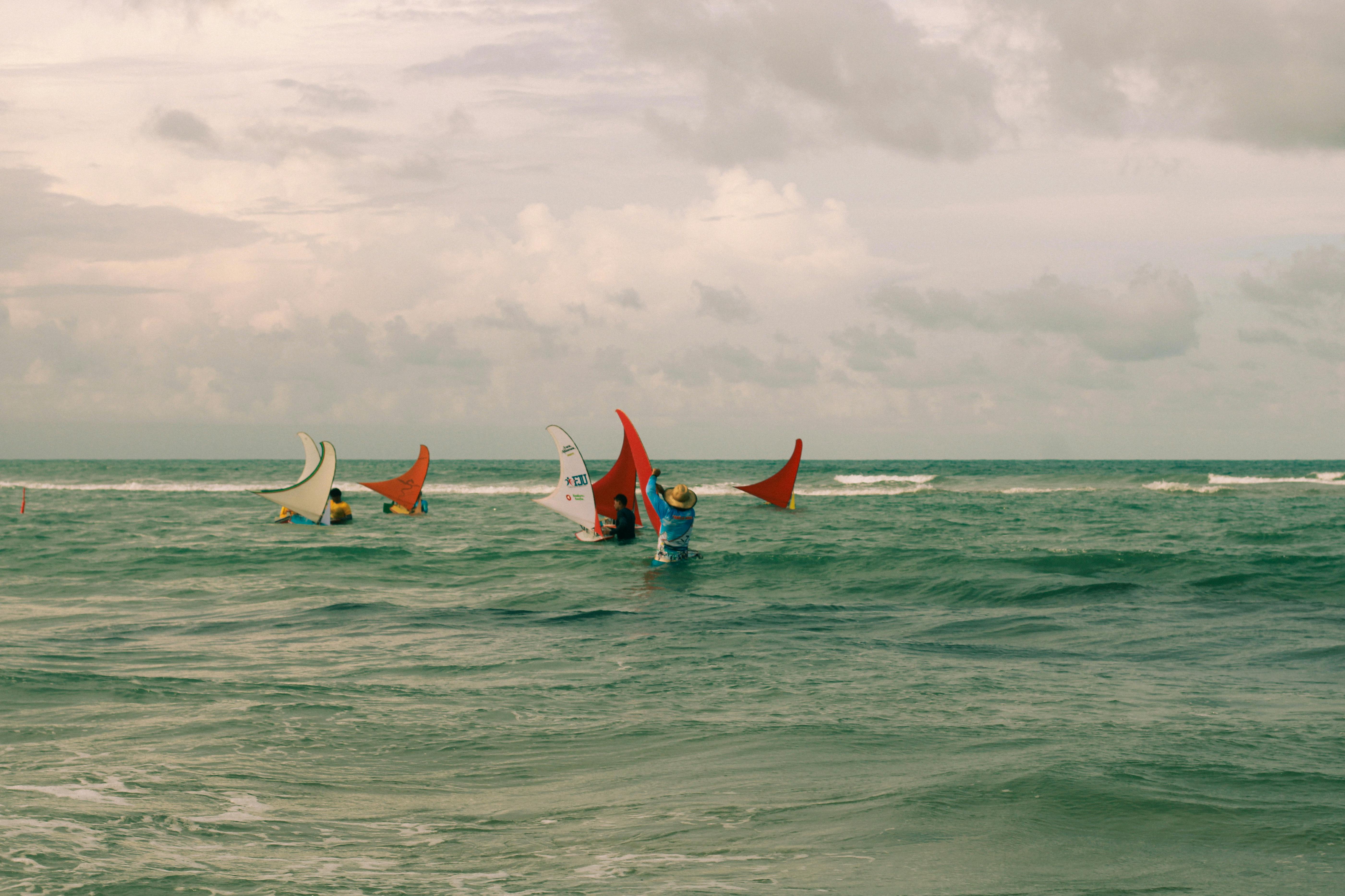 Immerse in the vibrant scene of jangada boats sailing on a Brazilian beach.