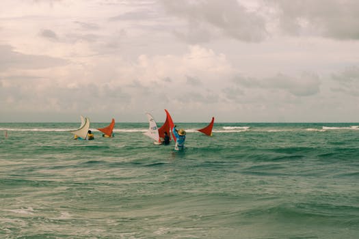 Immerse in the vibrant scene of jangada boats sailing on a Brazilian beach.