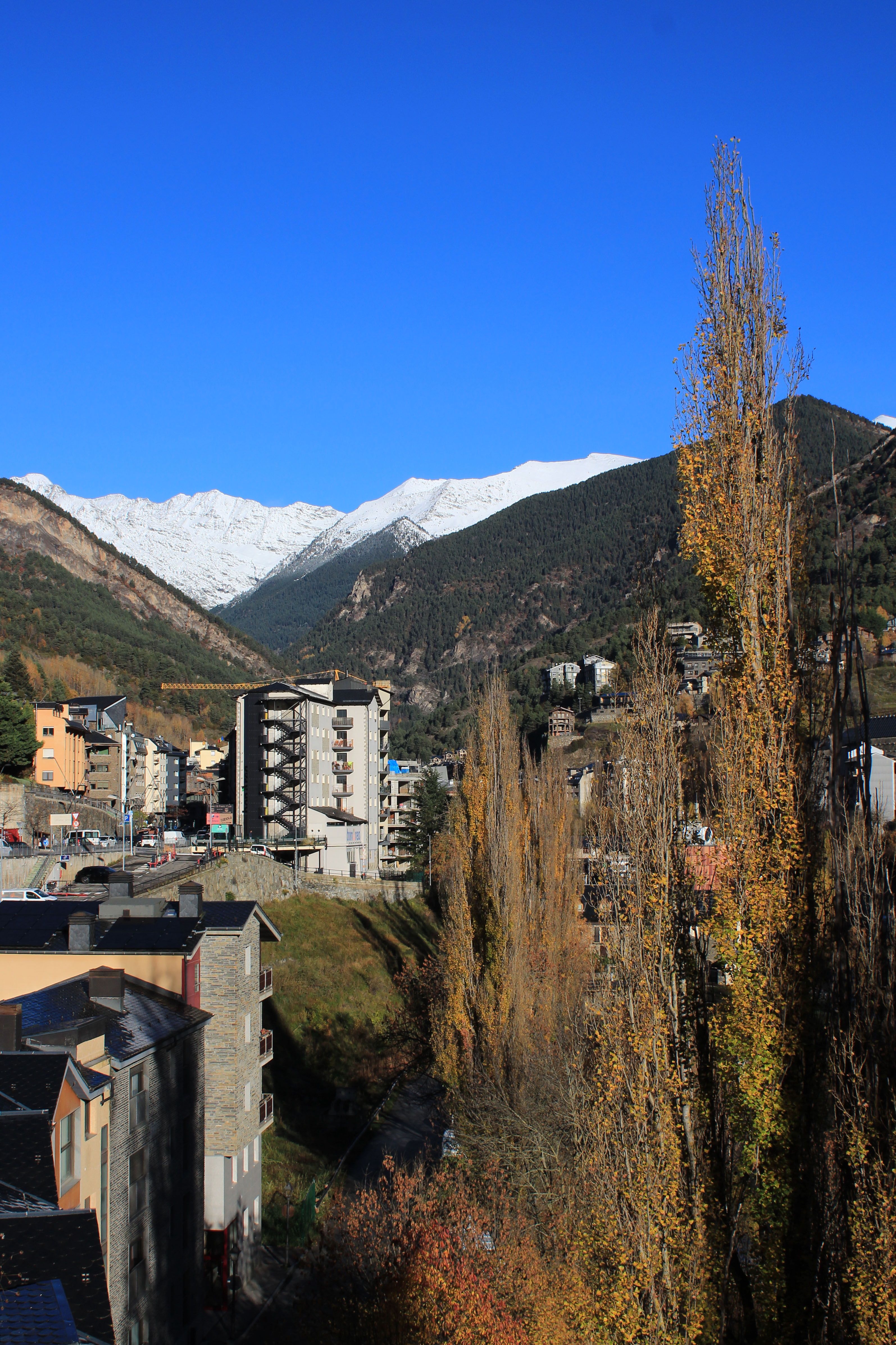 Beautiful landscape of La Massana, Andorra with snow-capped mountains and clear blue sky.
