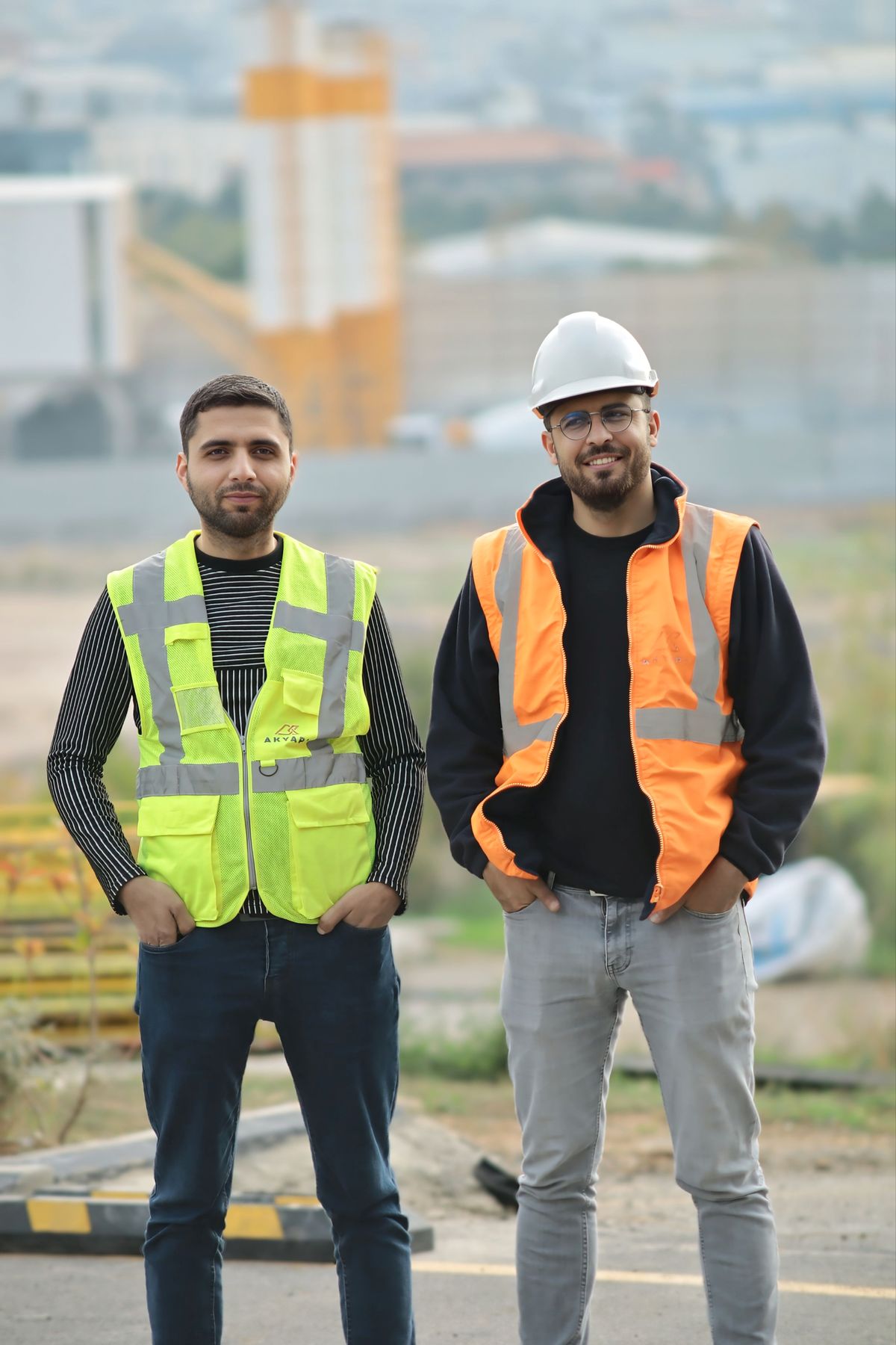 Two builders in safety gear on a building site
