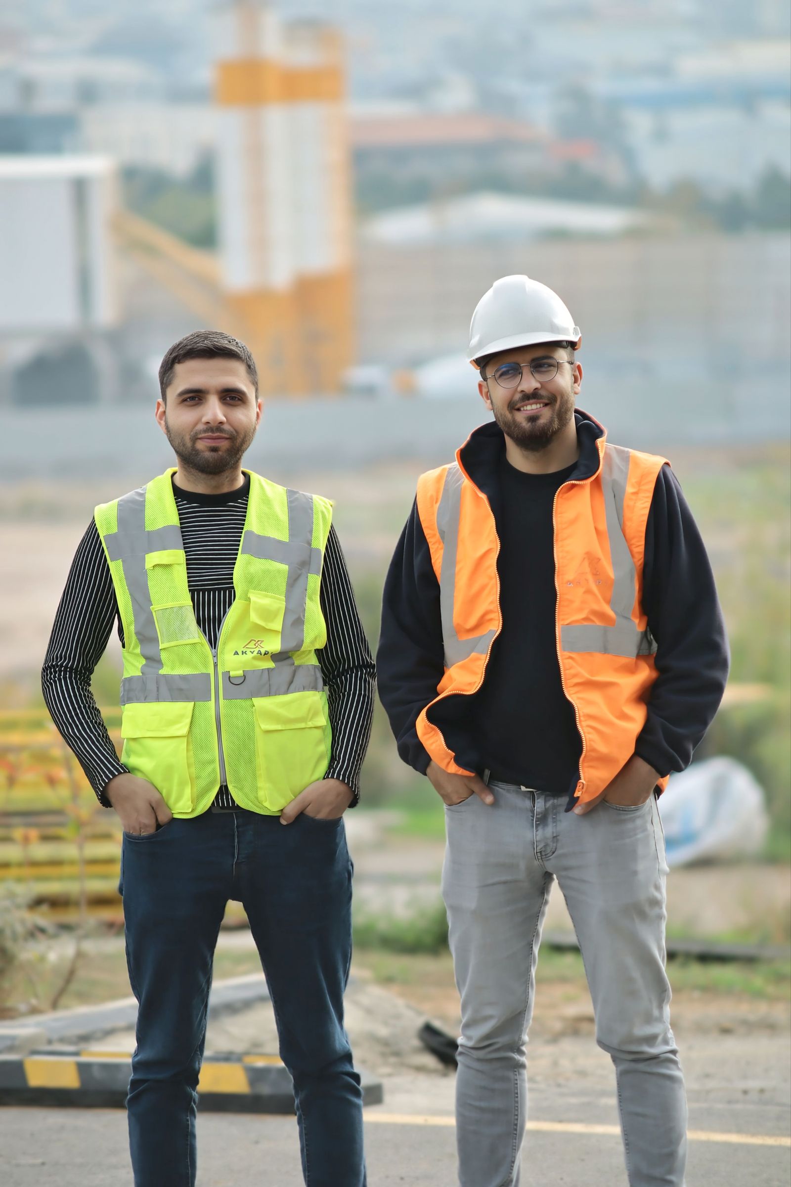 Two builders in safety gear on a building site