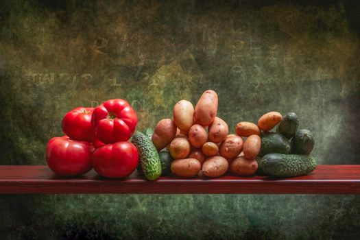A rustic display of fresh tomatoes, potatoes, and cucumbers on a wooden shelf against a textured background.
