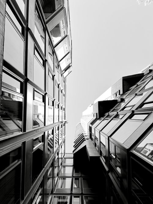 Free Striking black and white view of modern buildings from below. Stock Photo