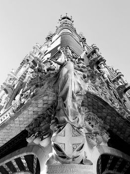 A towering architectural sculpture captured in a striking black and white style.