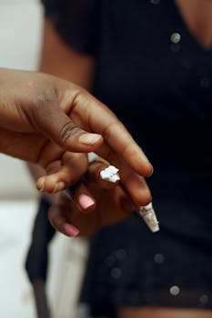 Detailed shot of two hands during a manicure with diverse skin tones.
