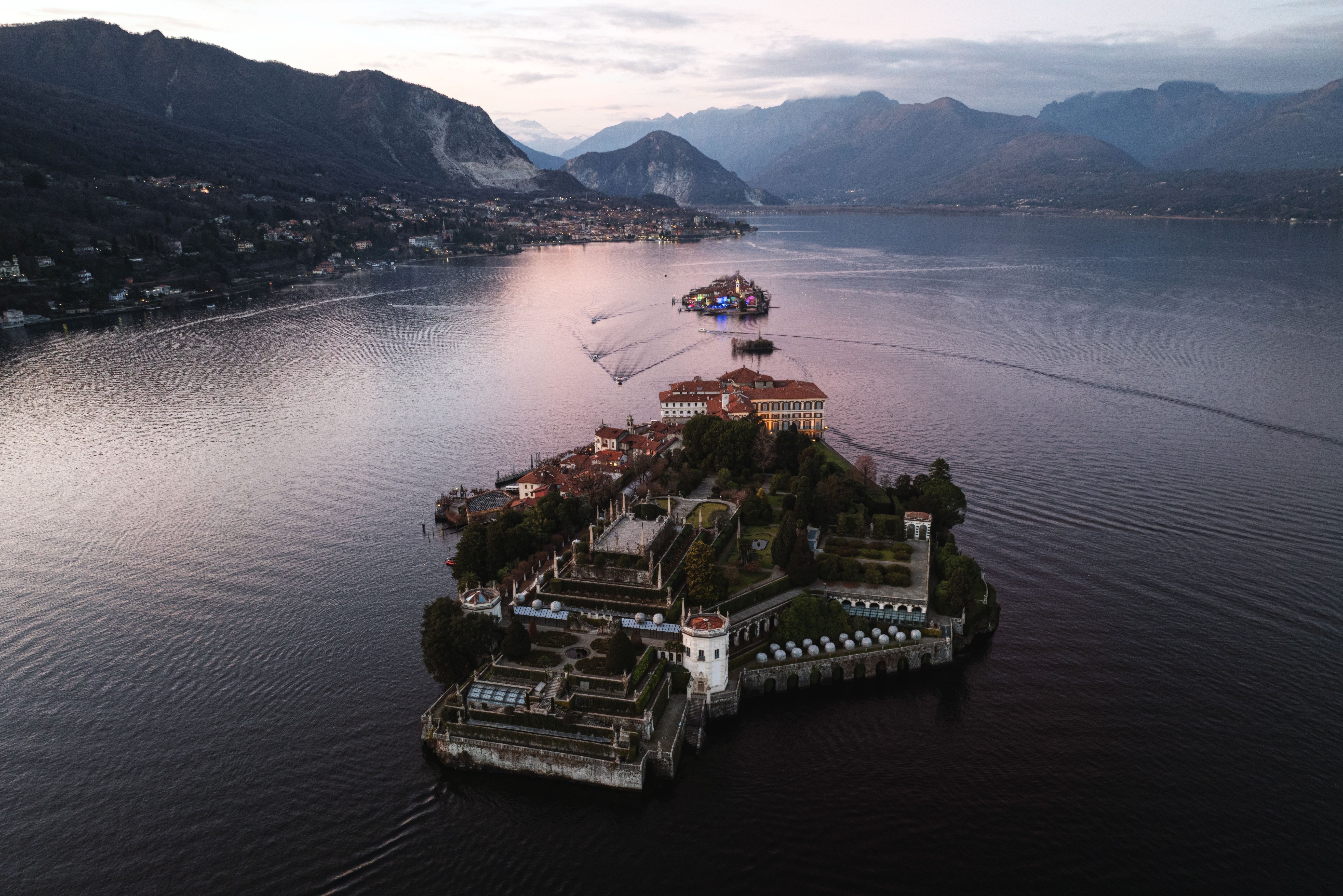 Stunning aerial view of Isola Bella on Lake Maggiore, Italy during sunset with mountainous backdrop. Stunning aerial view of Isola Bella on Lake Maggiore, Italy during sunset with mountainous backdrop.