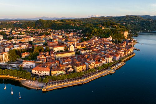 Free Stunning aerial view of Angera, Italy during sunset, showcasing vibrant architecture and Lake Maggiore. Stock Photo