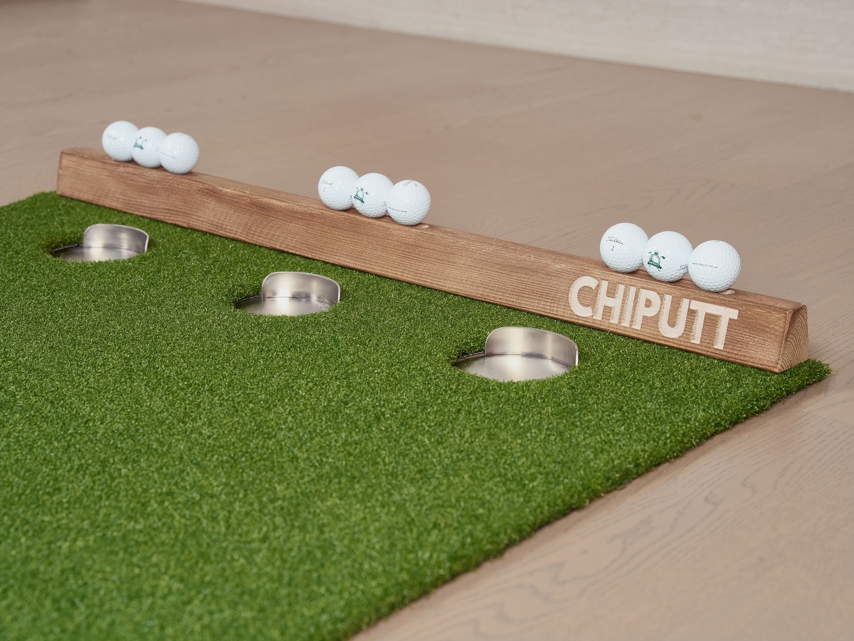 A golf putting mat with golf balls and holes, ideal for indoor practice.