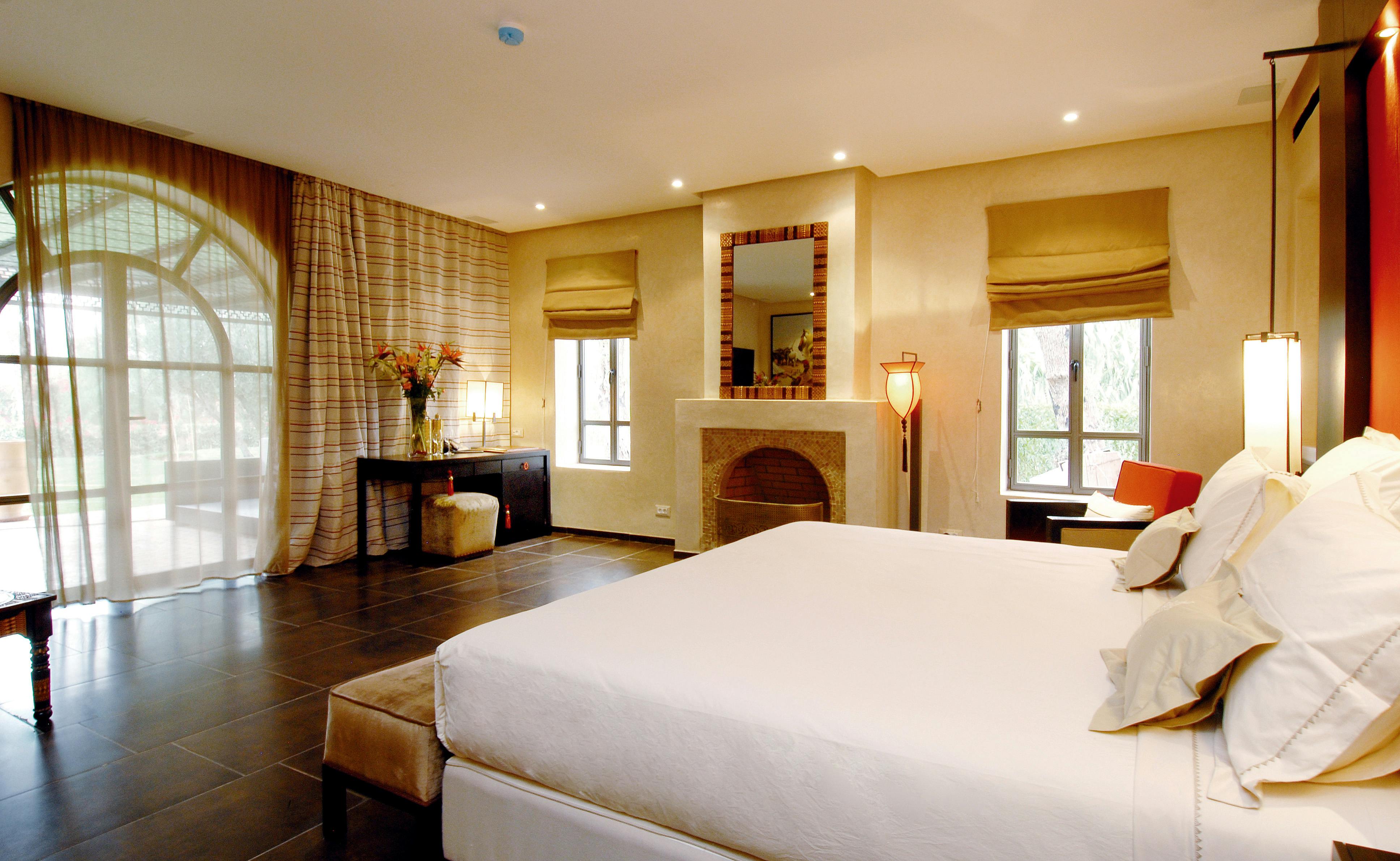 Free Spacious modern bedroom with elegant decor and large windows offering natural light. Stock Photo