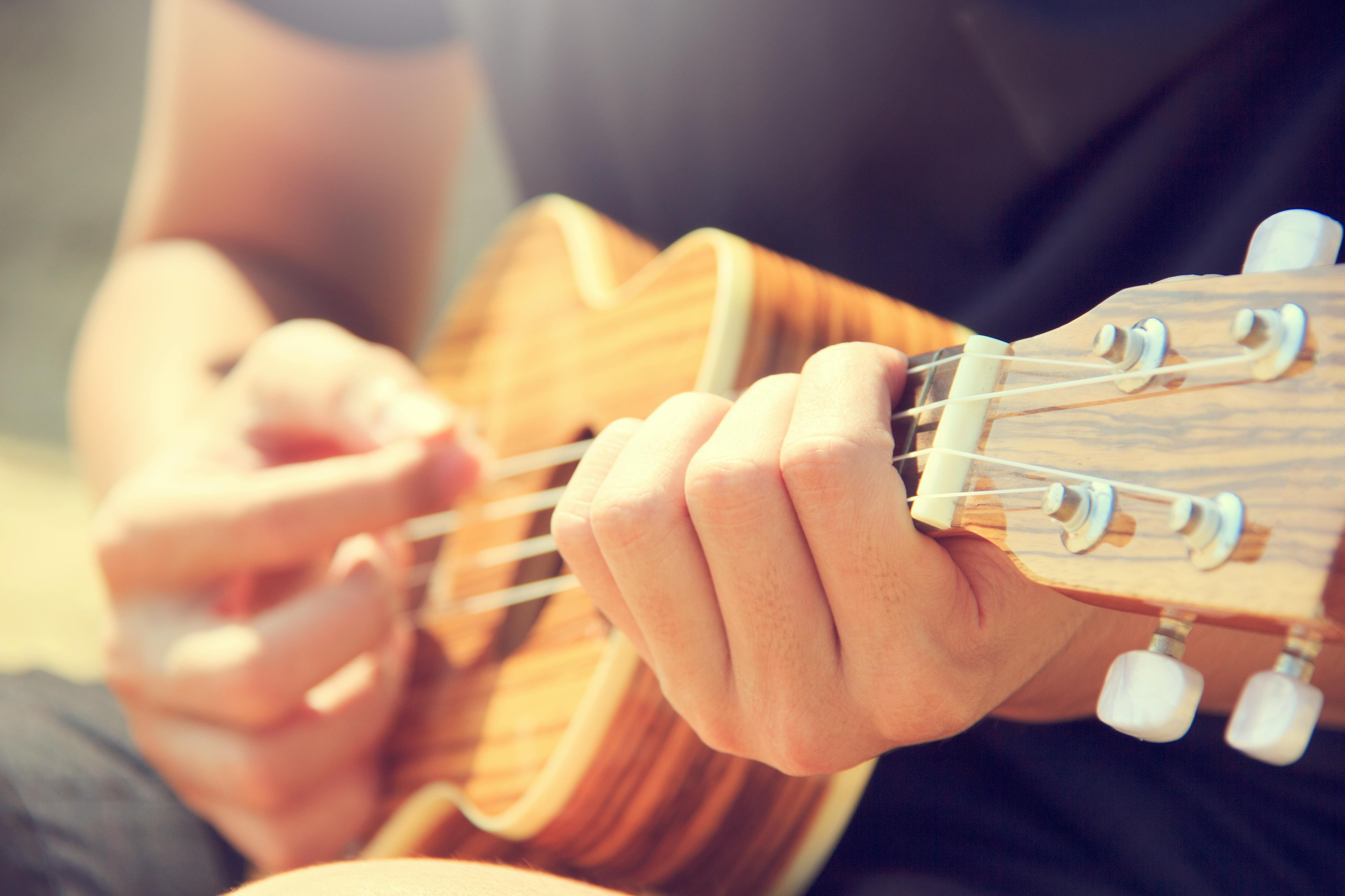 Person Playing Brown Ukulele · Free Stock Photo