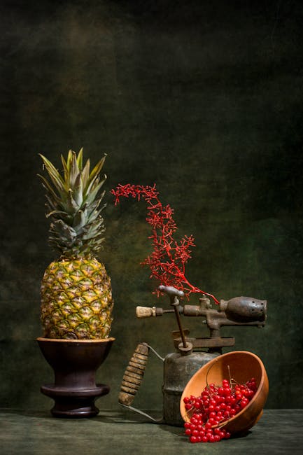 Vintage still life featuring a pineapple, red berries, and rustic objects against a dark backdrop.