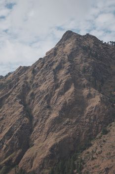 A stunning mountain peak captured during a cloudy day, showcasing natural beauty.