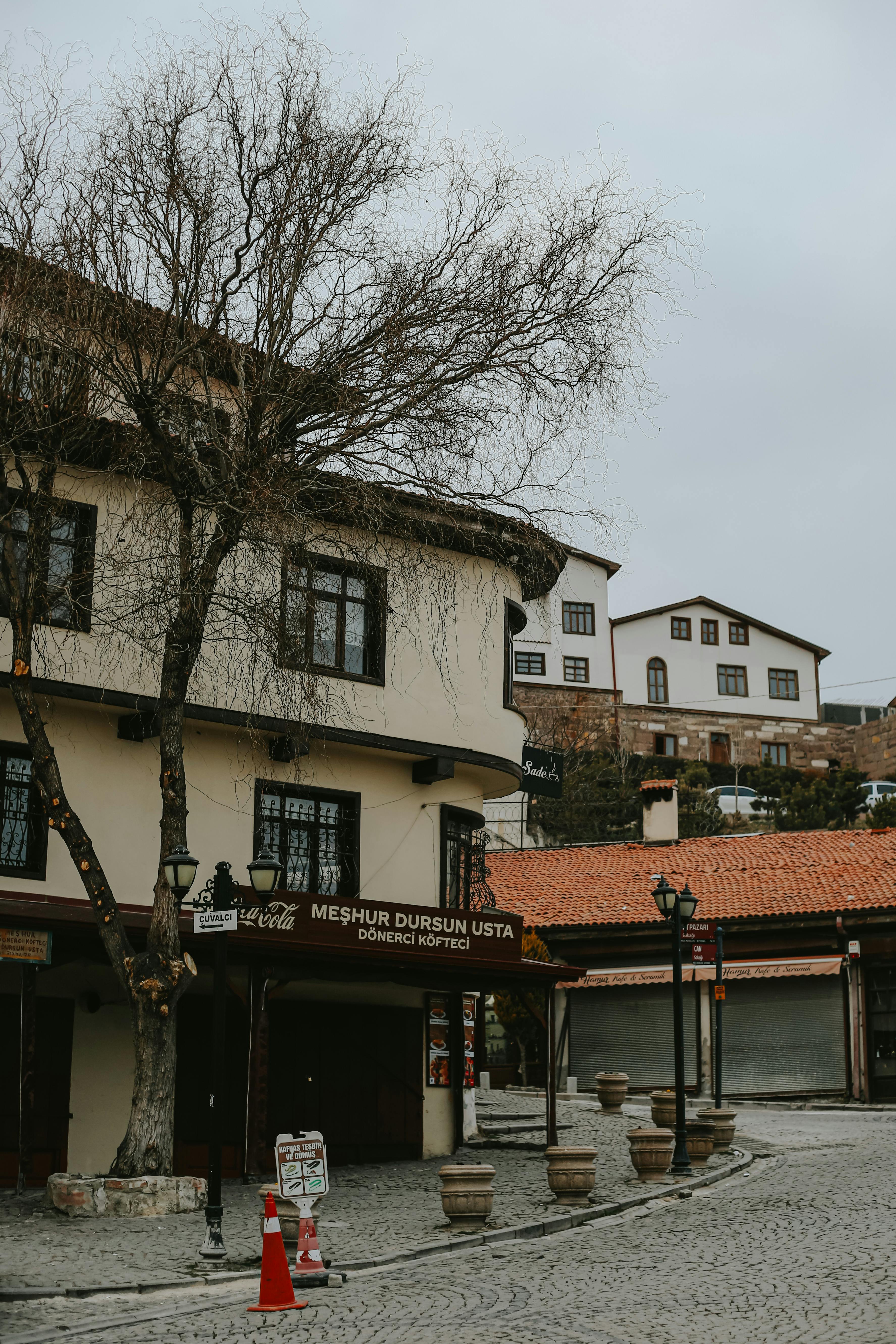 Scenic street view of a historical town with traditional architecture and cobbled pathways.