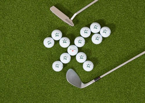 Free Golf balls with clubs on artificial turf, ideal for training. Stock Photo