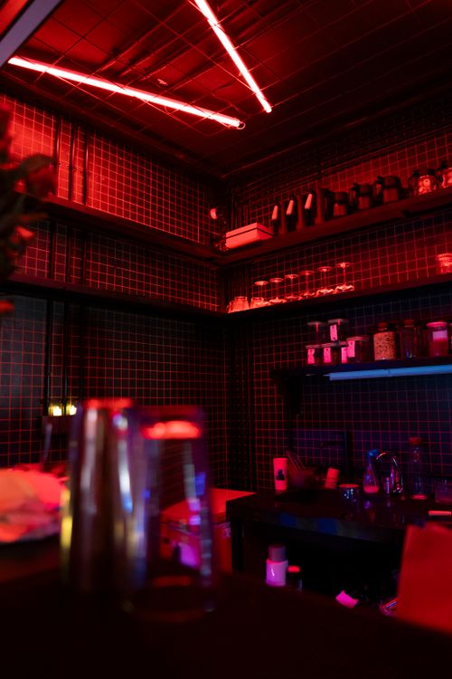 Free A neon-lit bar with shelves filled with bottles creating a vibrant atmosphere. Stock Photo