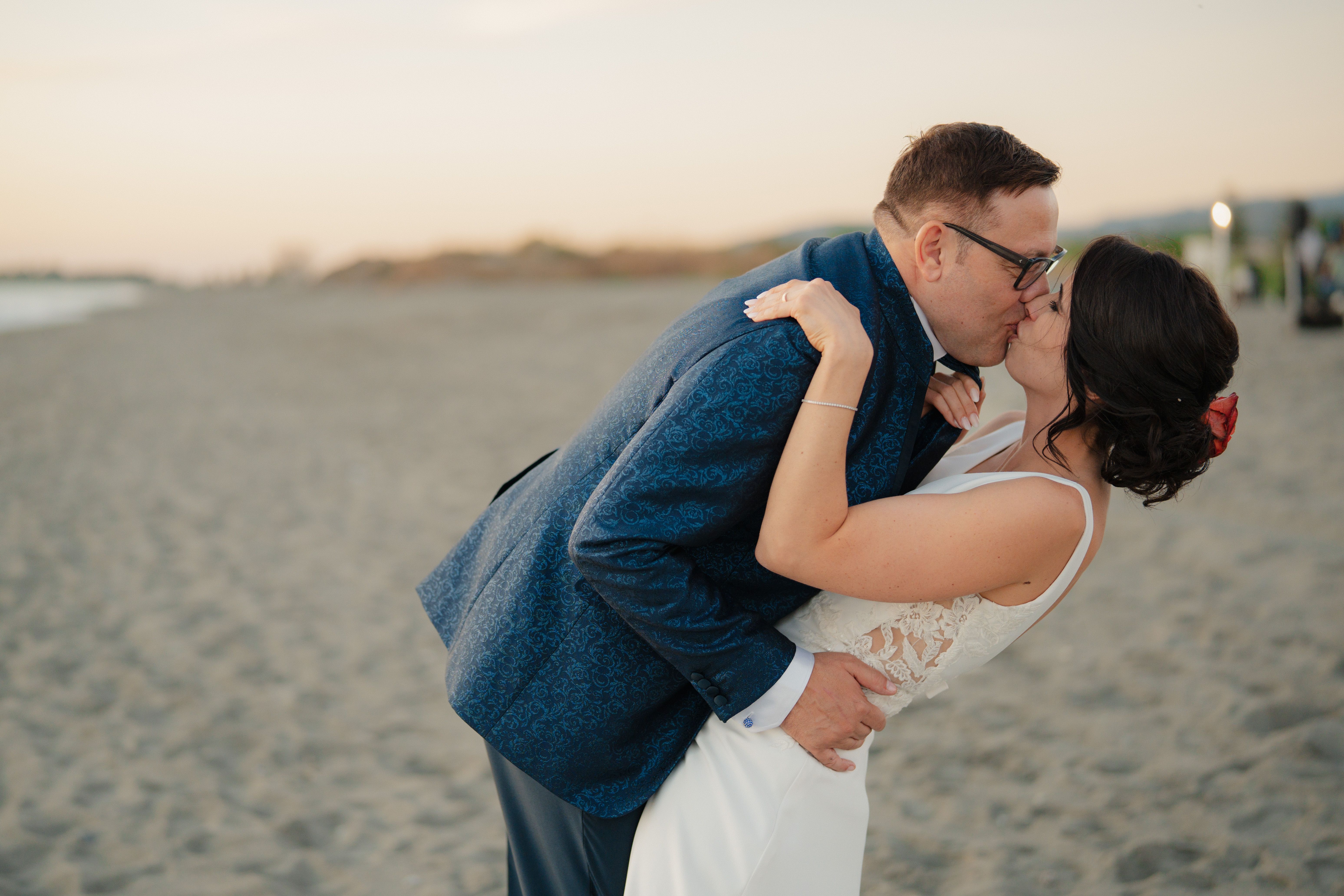 Romantic Beach Wedding Couple Embrace at Sunset · Free Stock Photo