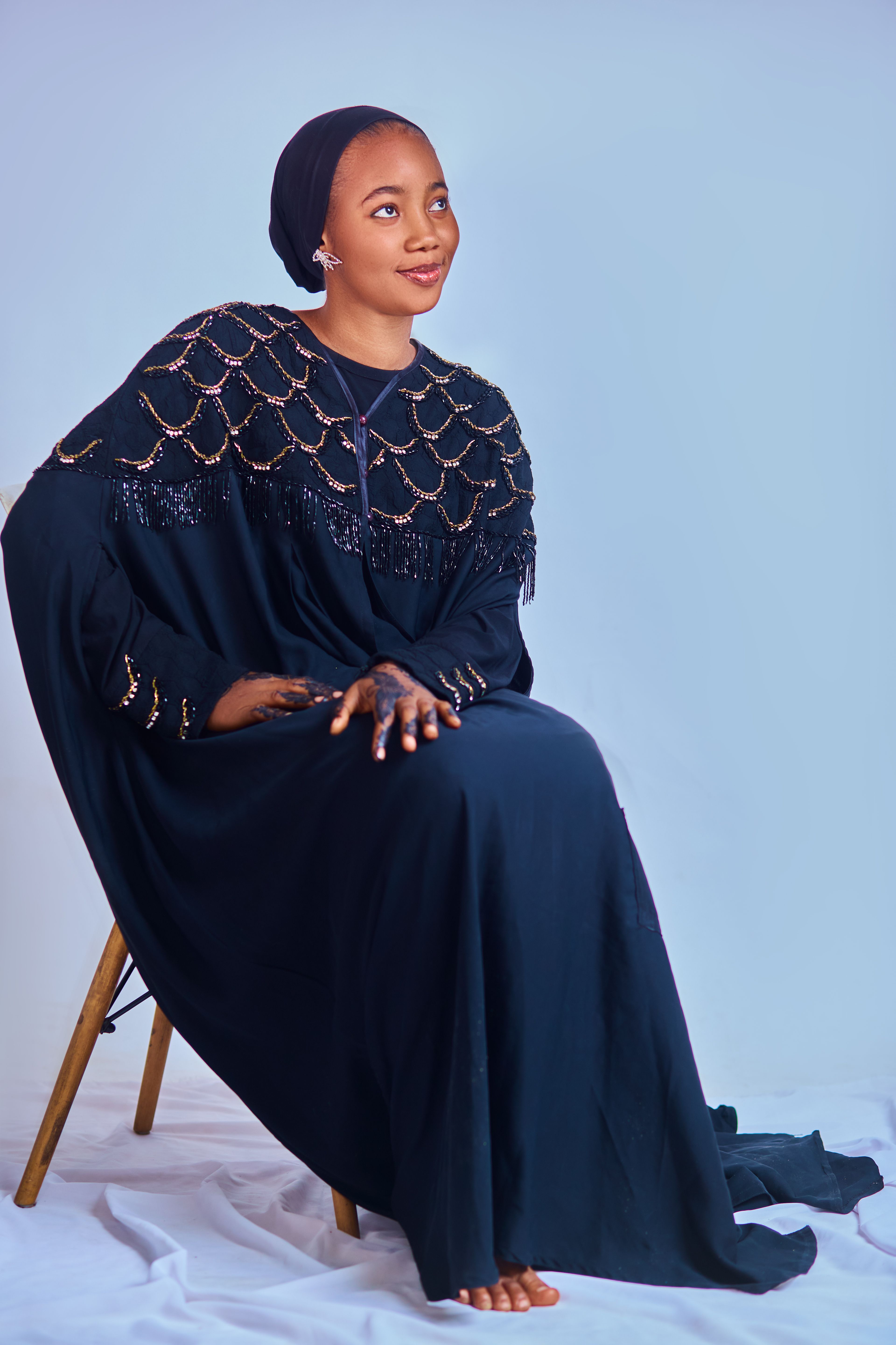 Elegant Woman in Traditional Dress Sitting on Chair · Free Stock Photo