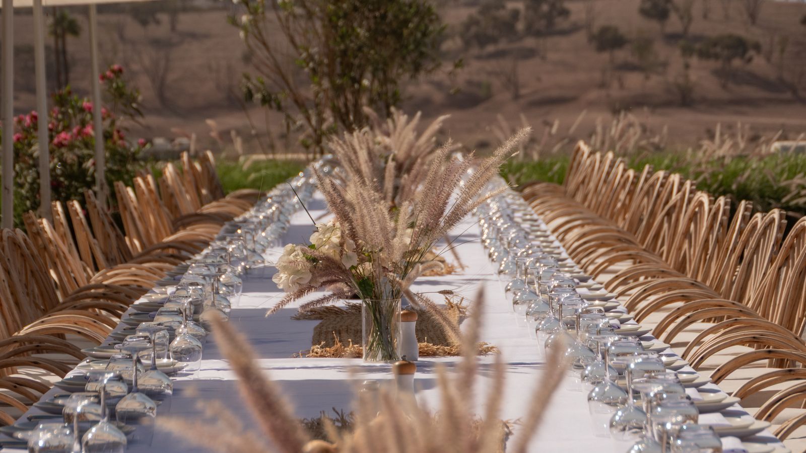 Beautifully arranged outdoor dining table with decorations, ready for a special event.
