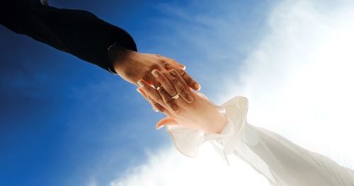 Free Two hands elegantly reaching towards the blue sky, symbolizing connection. Stock Photo