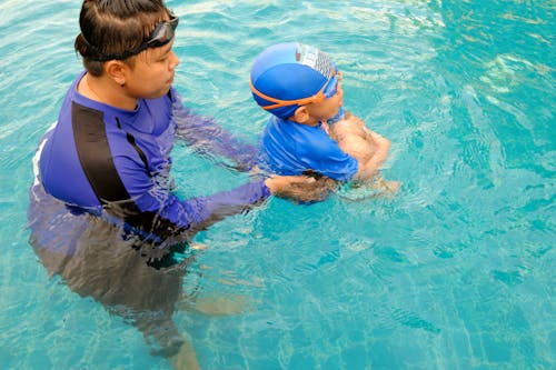 Chico En Cuerpo De Agua Con Hombre